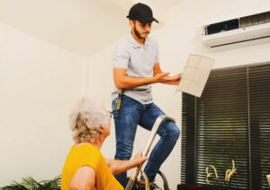 technician maintains ductless system in senior woman's home
