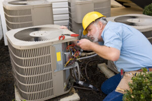 Repairman Works On Air Conditioning Unit