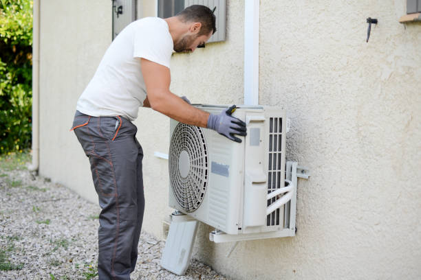 HVAC technician inspecting home heating system for maintenance