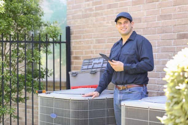 Licensed HVAC contractor from Expert Home Service performing a full furnace safety inspection.