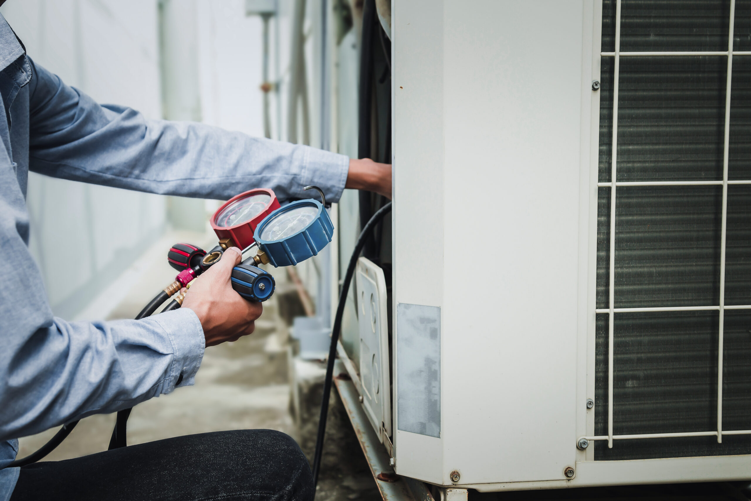AC technician assessing aging Florida HVAC system lifespan